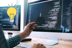 A person sitting in front of their PC, working on developing a website